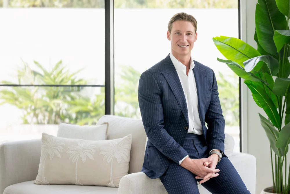 Tom Van seated in a suit